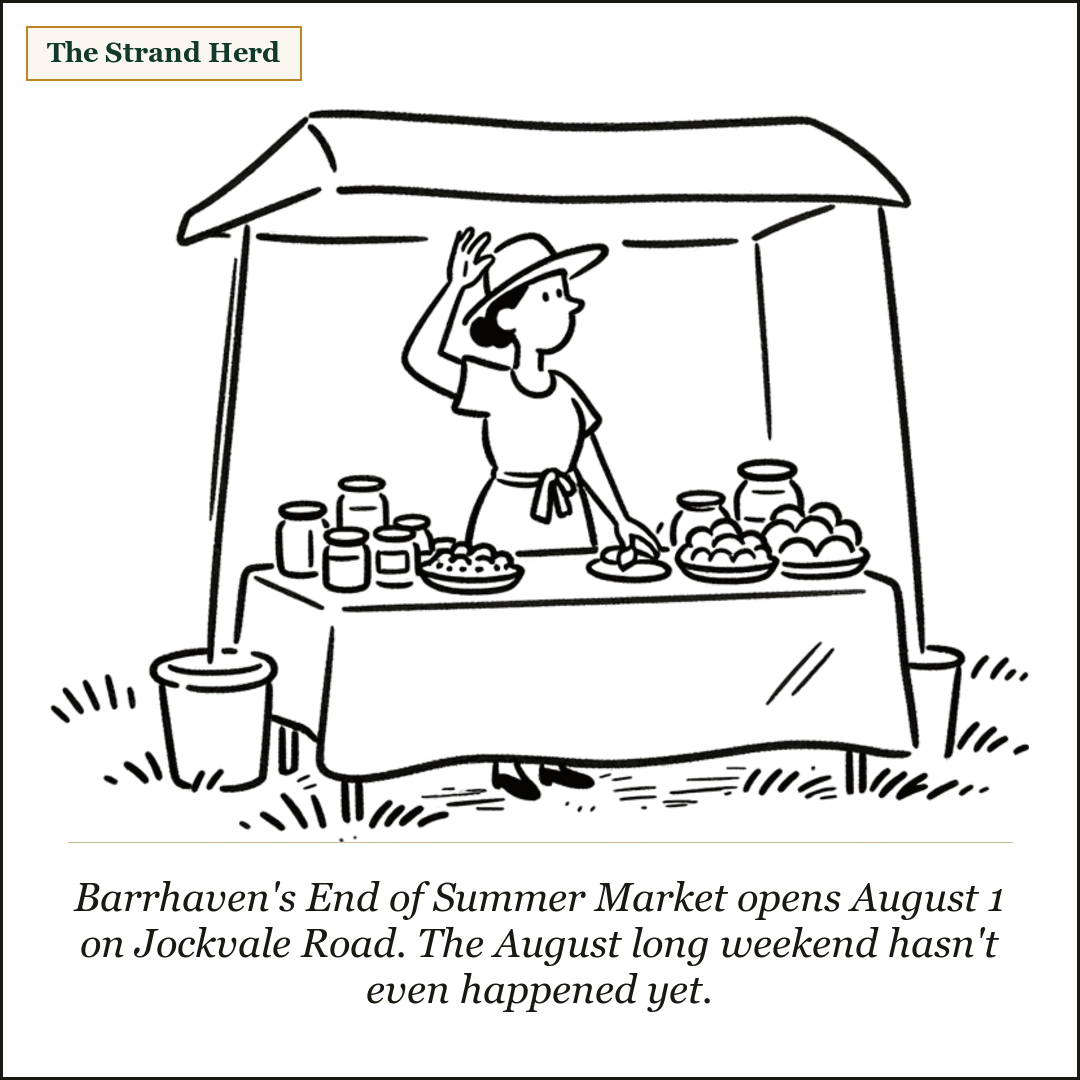 A market vendor stands behind a cloth-covered folding table of jars and baked goods under an open canopy on a grassy lawn, shading her eyes in the summer heat.