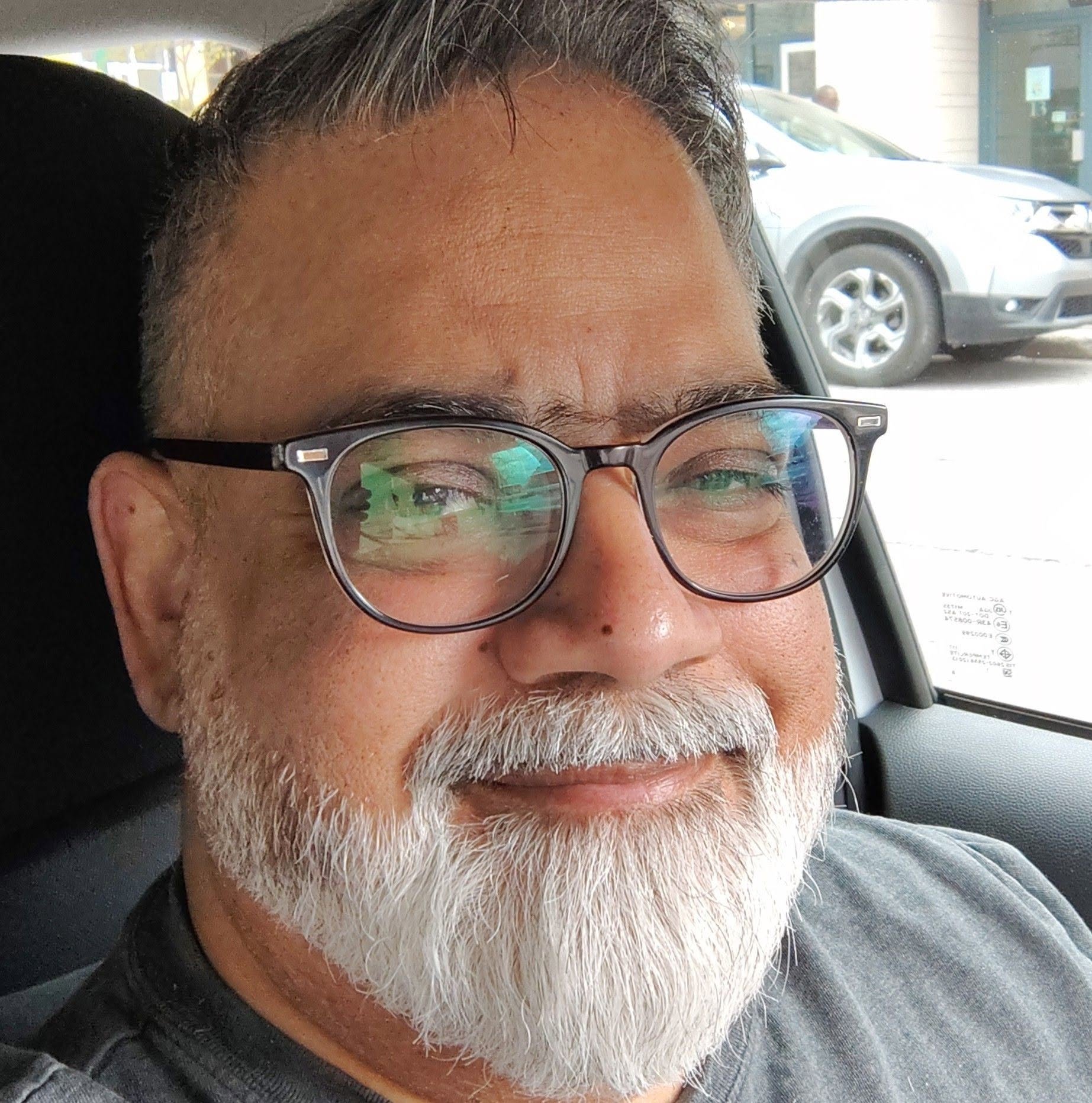 Omer Humayun, founder of Unity Audio Canada, in glasses and a grey t-shirt.