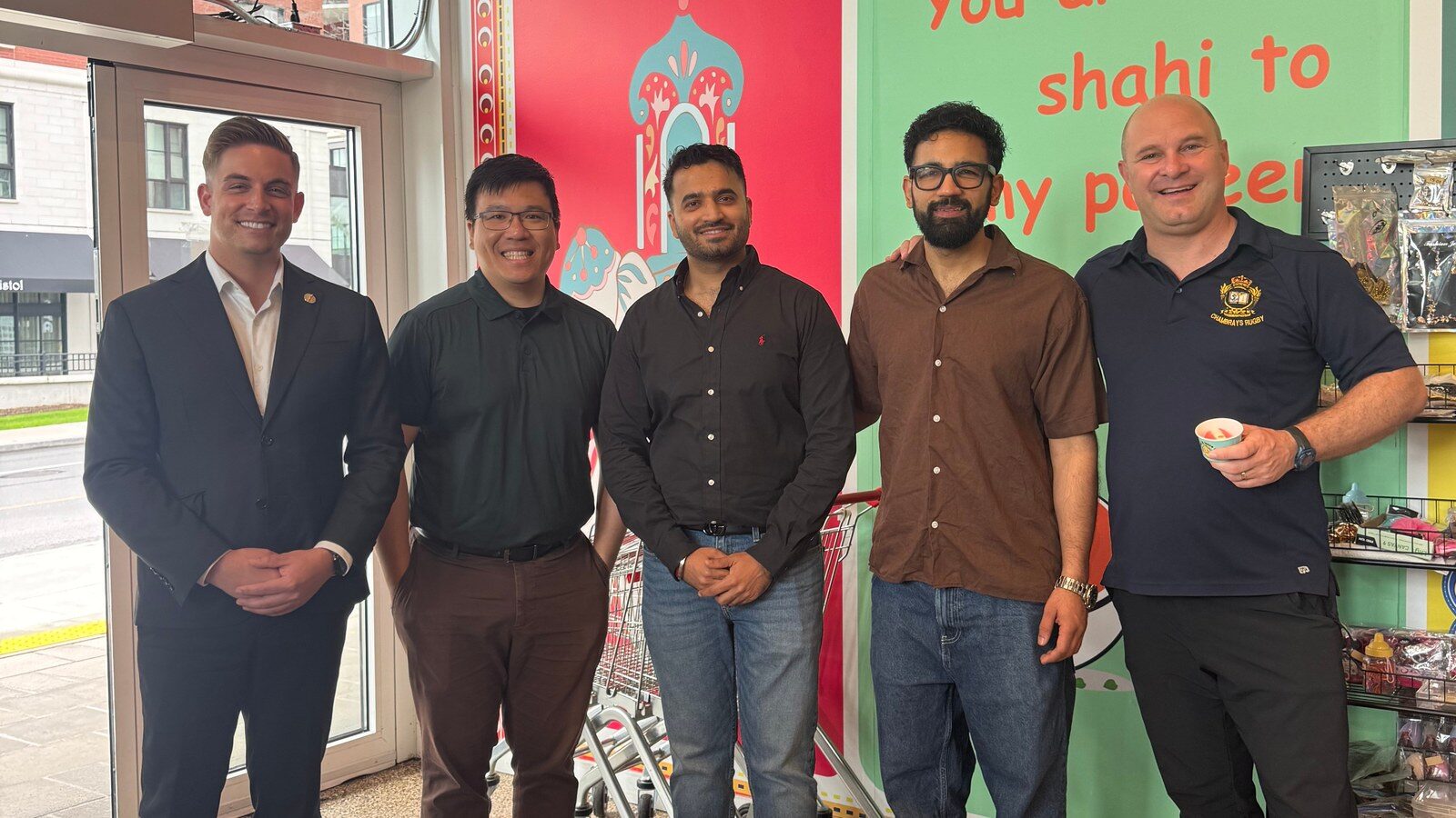 MPP Tyler Watt and local officials with Barrhaven Indian Bazaar representatives inside the Marketplace Avenue store during the grand opening.
