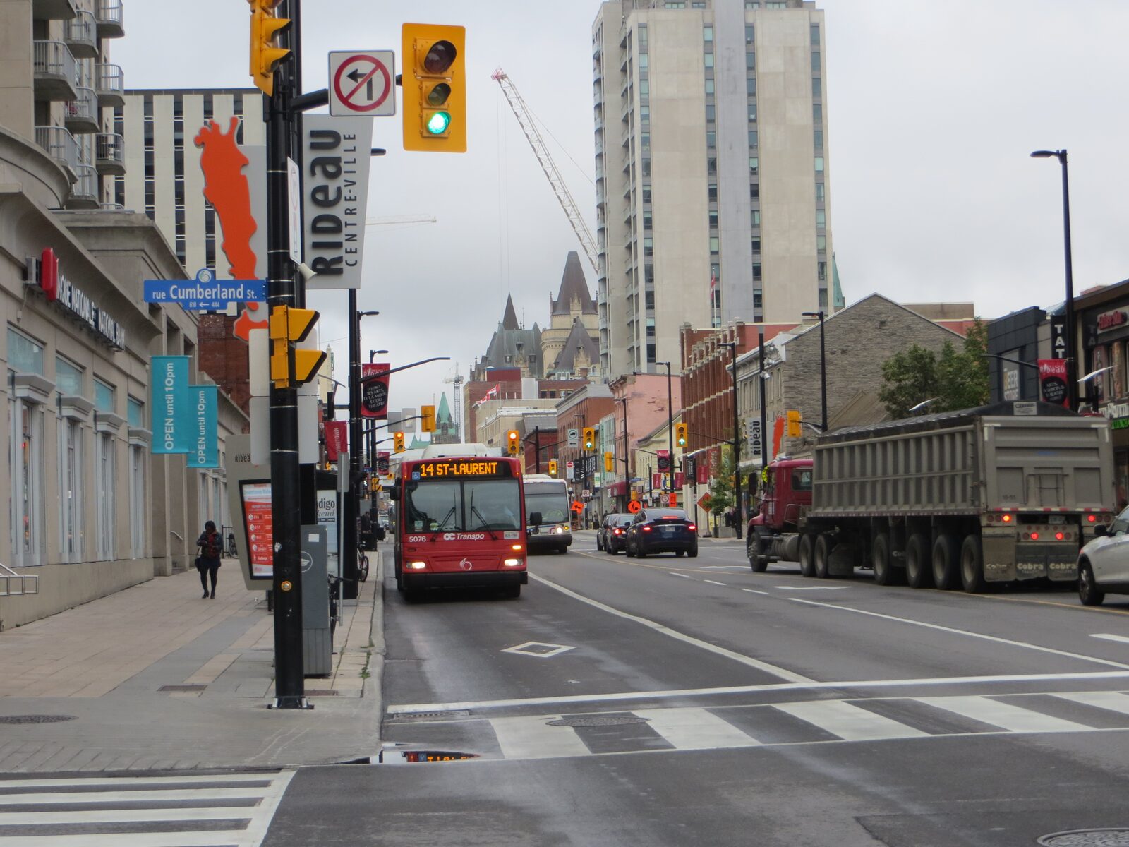 A red and white OC Transpo bus on Rideau Street in downtown Ottawa.